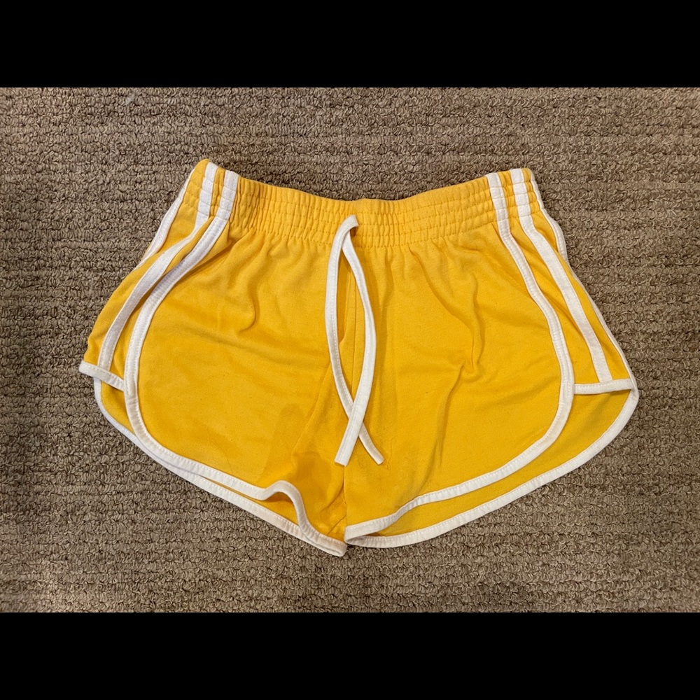 Yellow dolphin shorts with white stripes on the side!